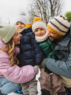 Family laughing outdoors