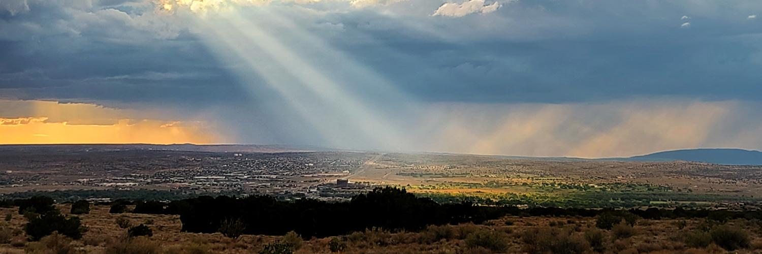 A stormy view over a town and desert