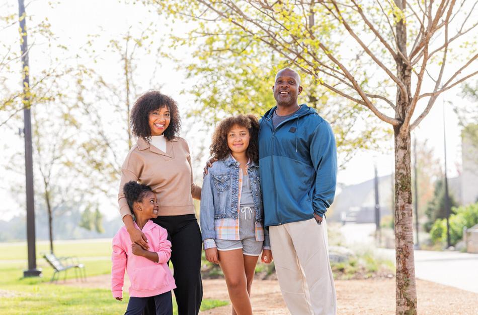 family smiling in a park
