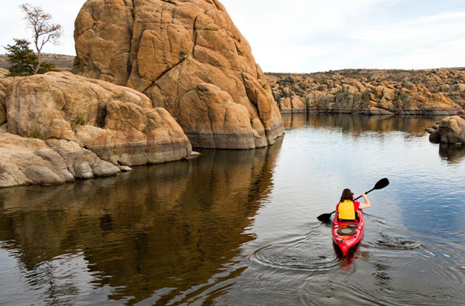 picture of someone kayaking through the mountains