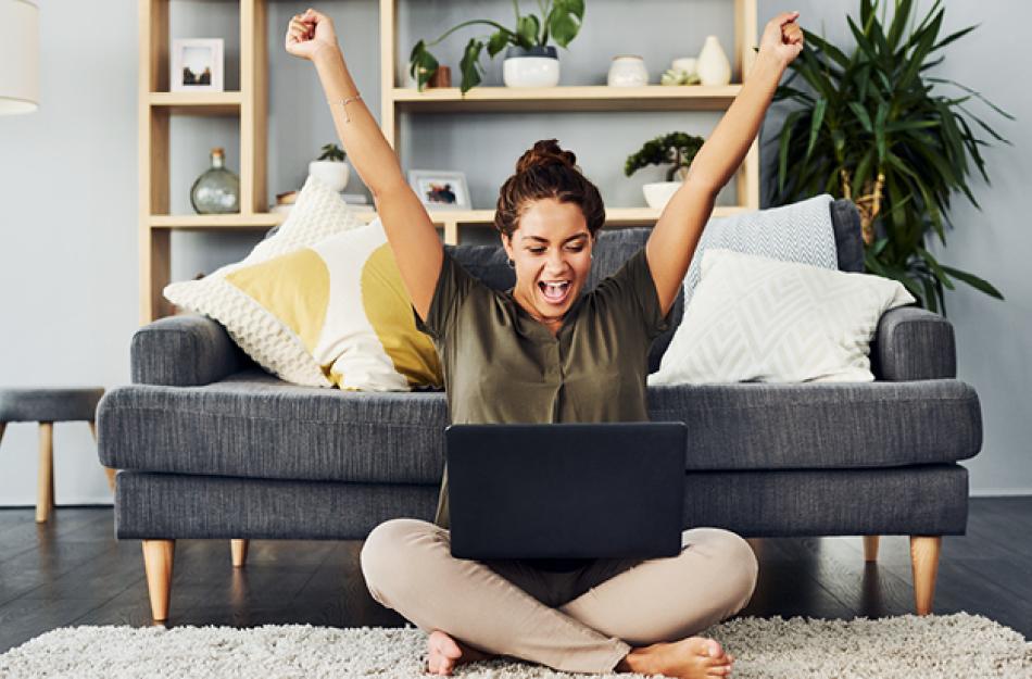 woman excited about something on her computer