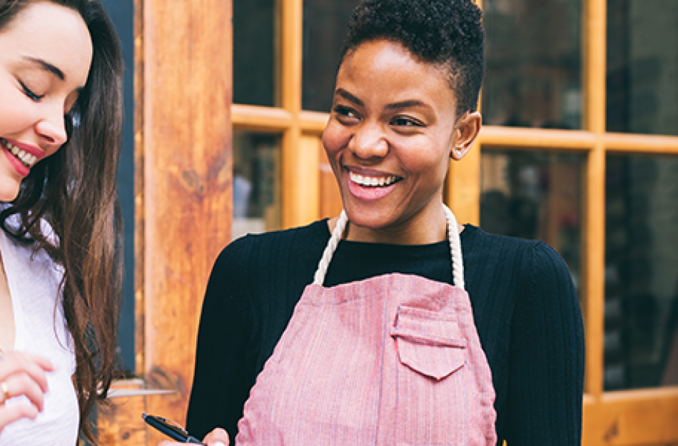 picture of a woman talking with her customer outside the door