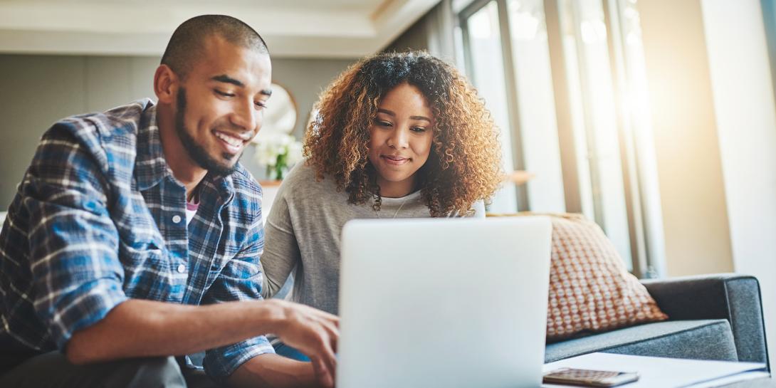 man and woman looking at the computer