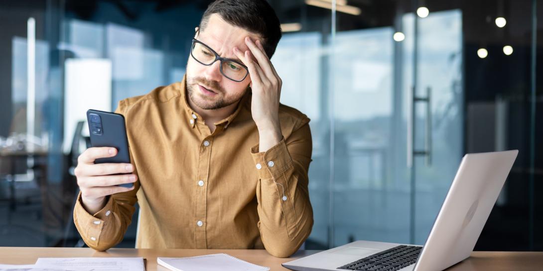 Man looking at his phone while at work